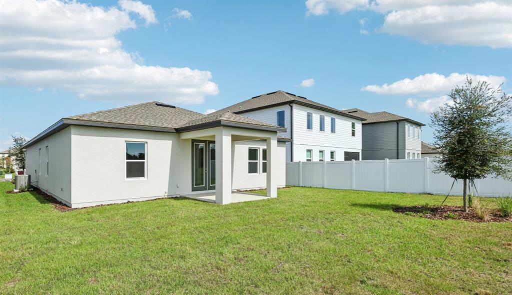 5740 Haystack Drive St. Cloud, FL 34771 - Photo 38 of 39 a view of a house with a yard and fence