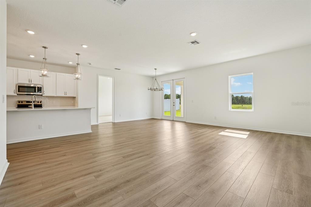 5740 Haystack Drive St. Cloud, FL 34771 - Photo 6 of 39 a view of an empty room with wooden floor and a window