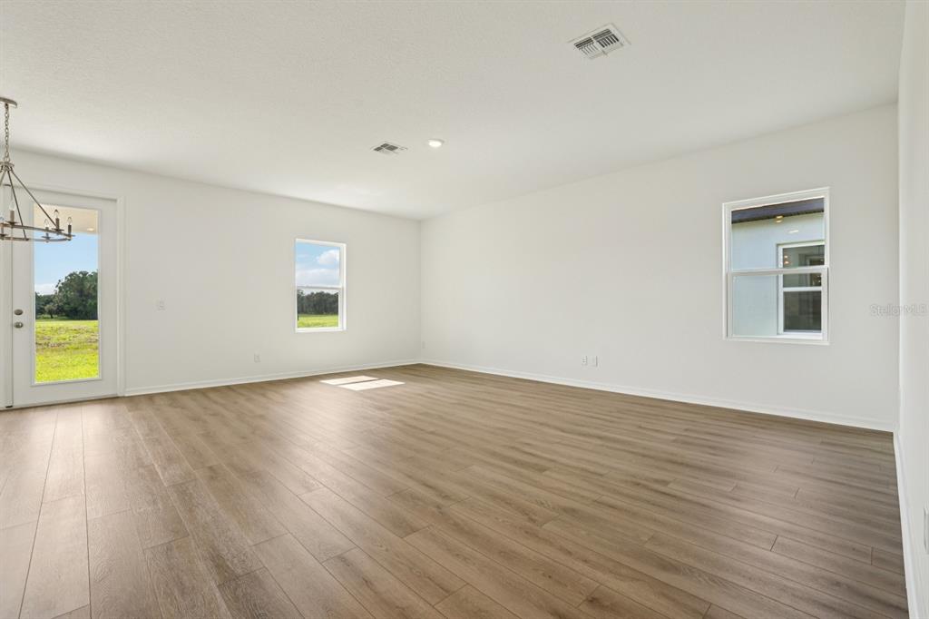 5740 Haystack Drive St. Cloud, FL 34771 - Photo 7 of 39 an empty room with wooden floor and windows
