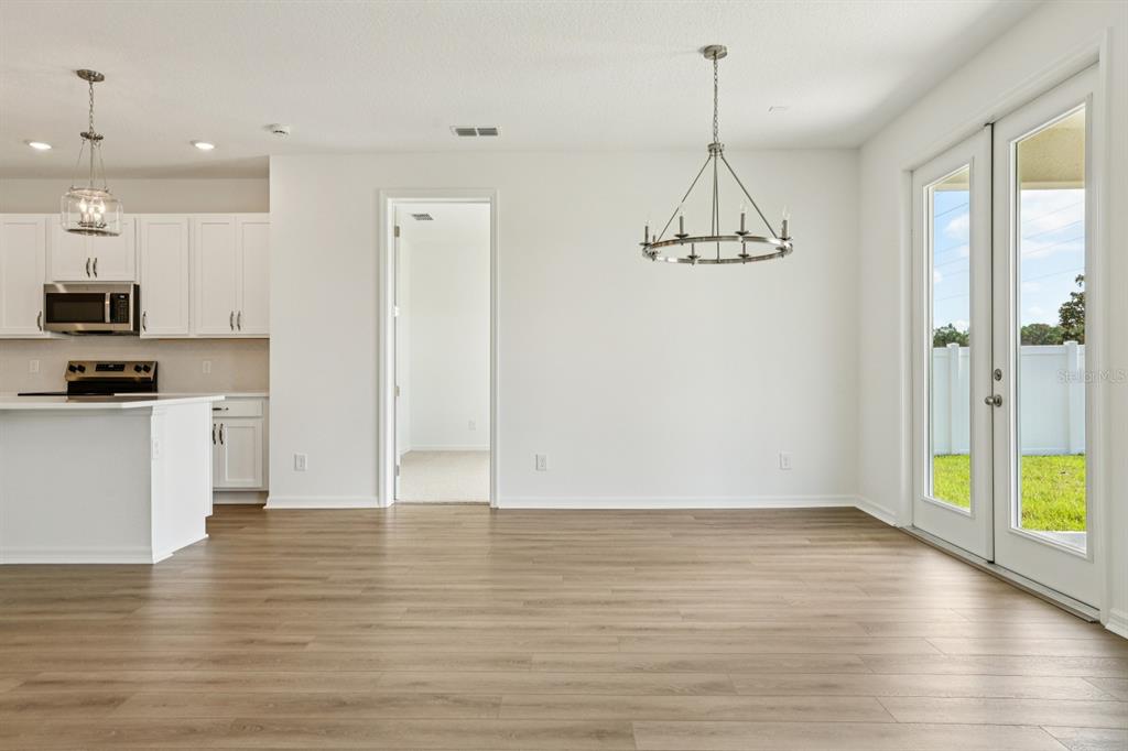 5740 Haystack Drive St. Cloud, FL 34771 - Photo 9 of 39 a view of a kitchen with wooden floor and a window