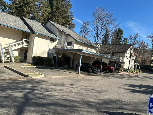 a view of a room with wooden floor and windows