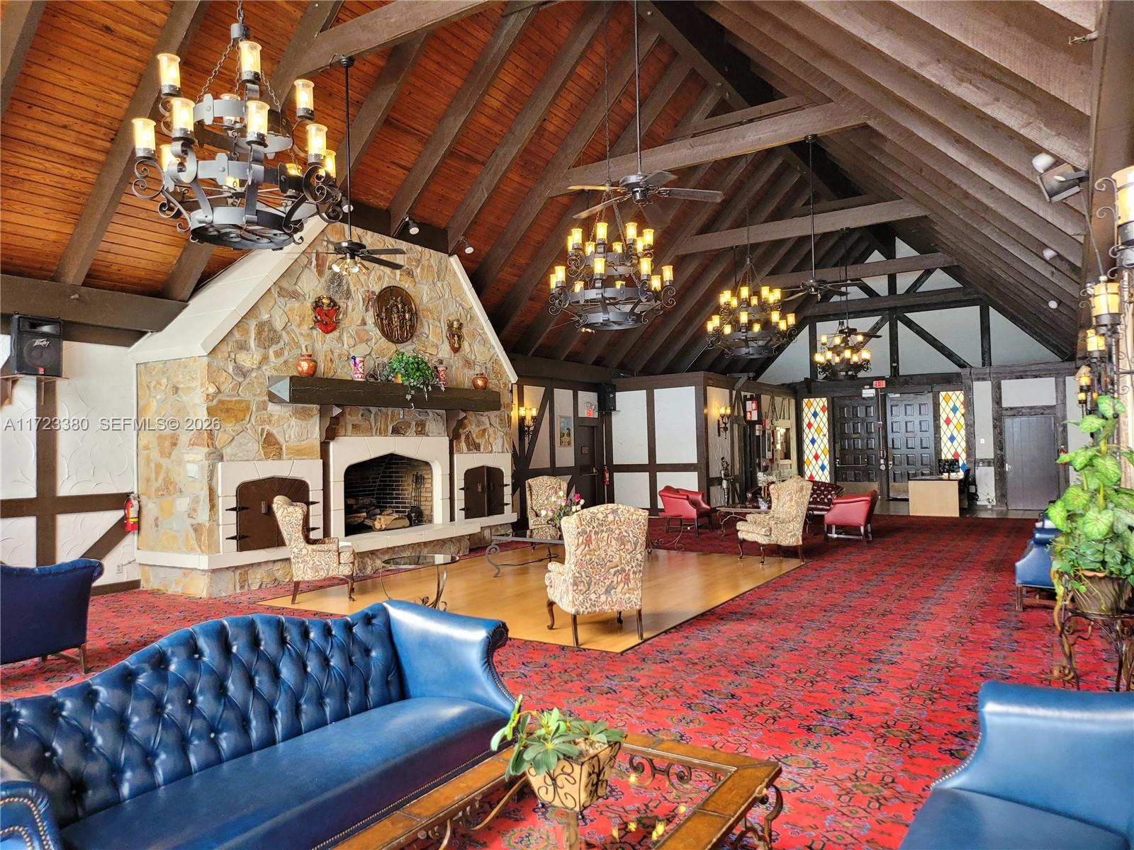 3750 Inverrary Drive, Unit 2Y Lauderhill, FL 33319 - Photo 20 of 44 a living room with furniture a fireplace and lots of windows