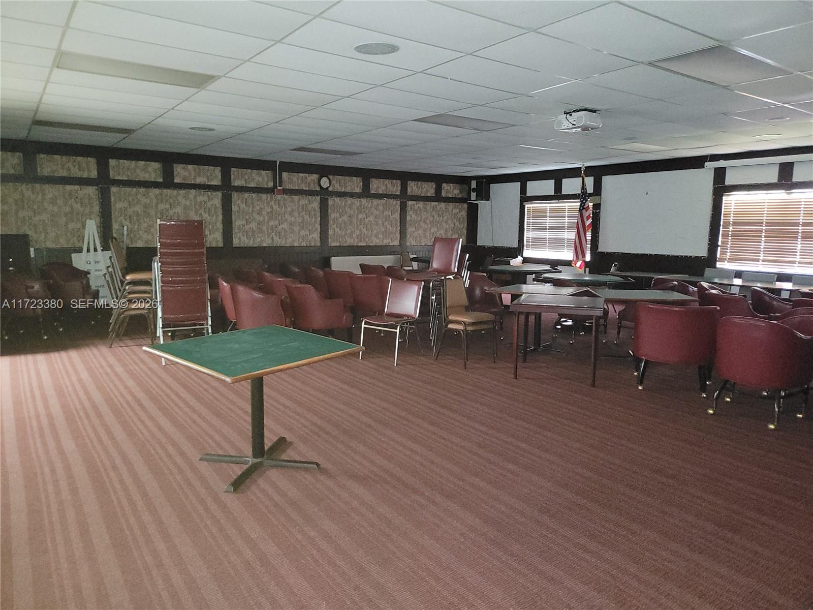 3750 Inverrary Drive, Unit 2Y Lauderhill, FL 33319 - Photo 37 of 44 a living room with furniture a rug potted plant and a window