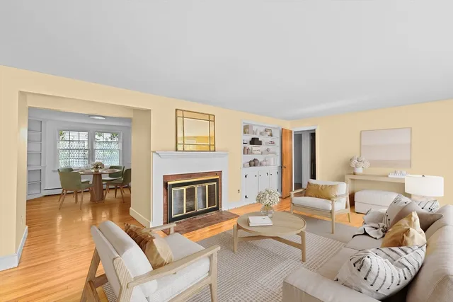 a living room with furniture fireplace and a table