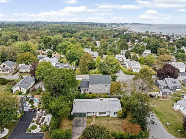 an aerial view of residential houses with outdoor space and river