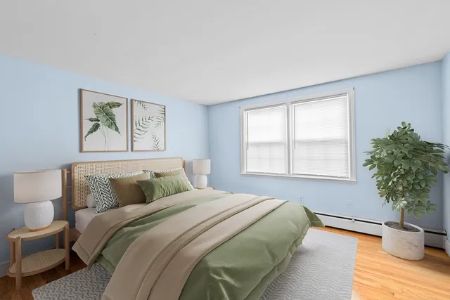 a bedroom with a bed and a potted plant