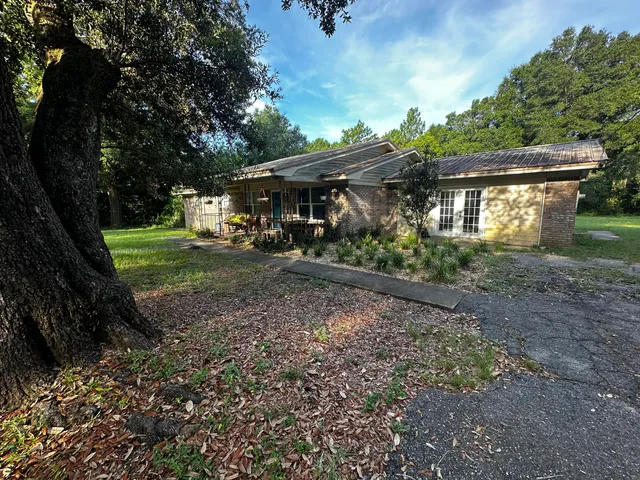 a view of a house with yard and a garden