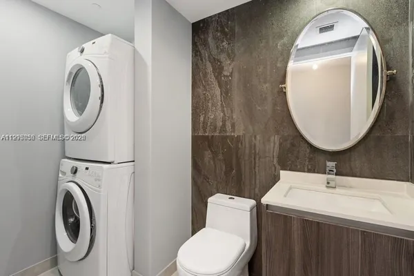 a bathroom with a sink mirror and toilet