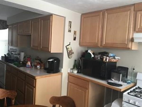 150 Sumner Street, Unit 1 Quincy, MA 02169 - Photo 2 of 10 a kitchen with a sink and cabinets