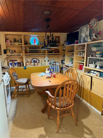 a outdoor dining space with furniture and flat screen tv
