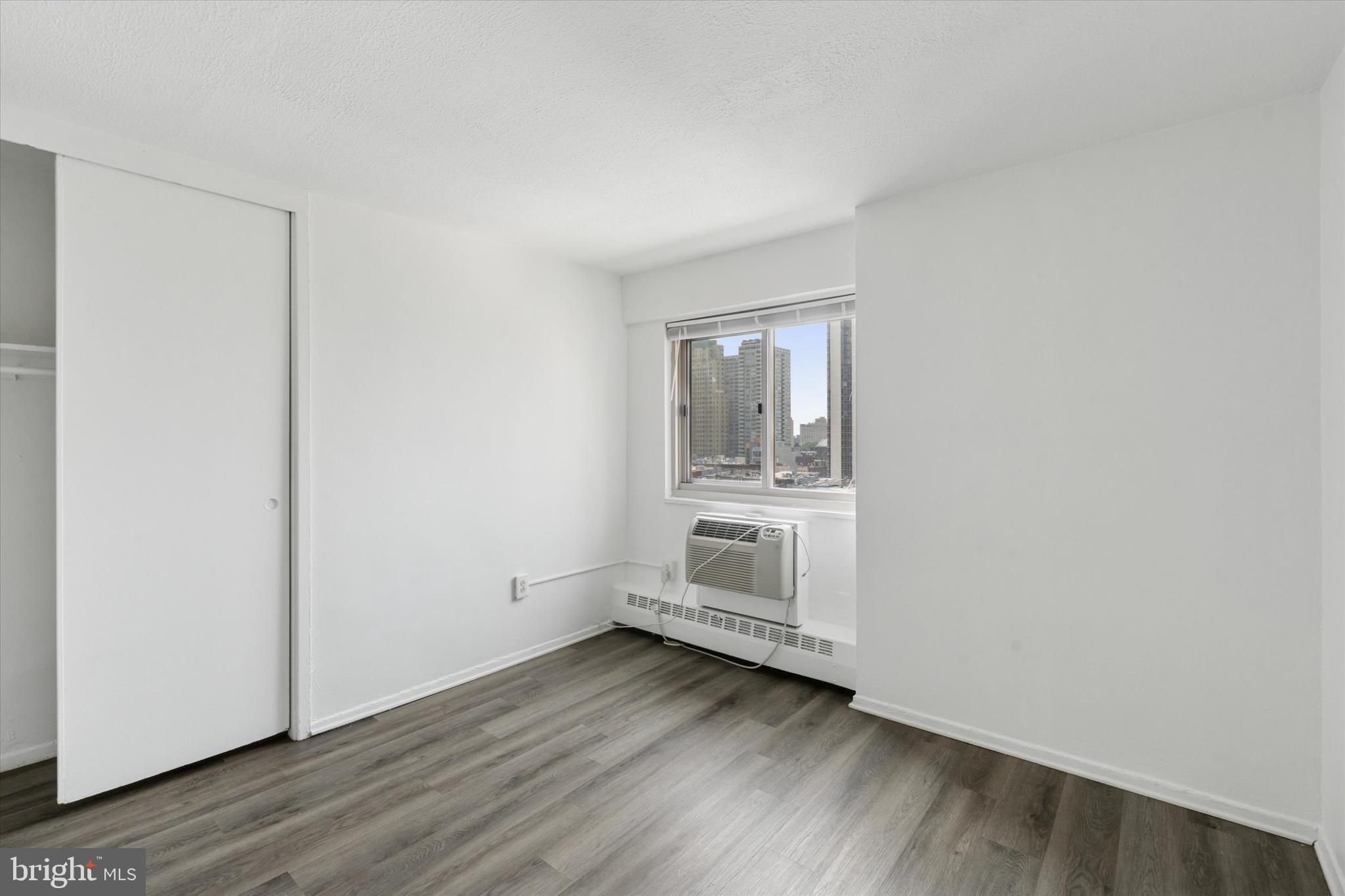 2101 Chestnut Street, Unit 1208 Philadelphia, PA 19103 - Photo 13 of 15 a view of wooden floor and windows in a room