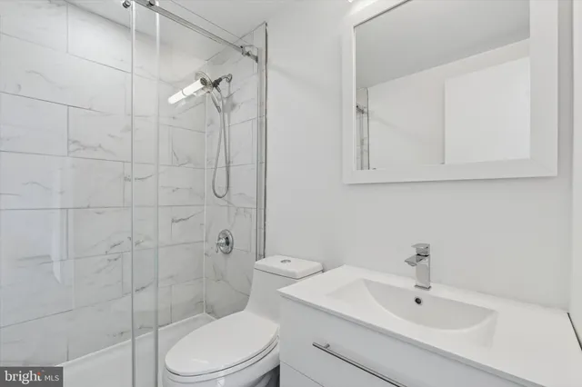 a bathroom with a toilet sink and shower