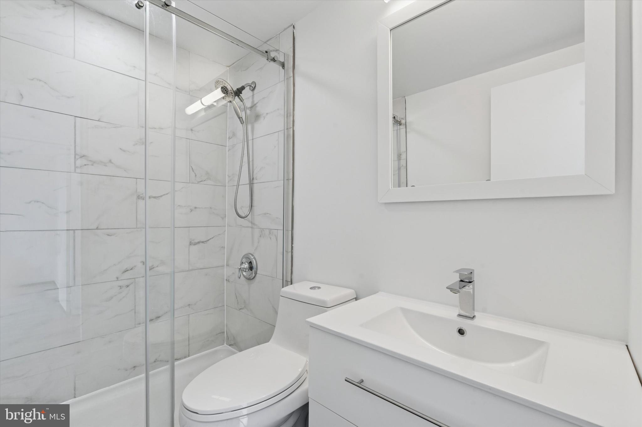2101 Chestnut Street, Unit 1208 Philadelphia, PA 19103 - Photo 14 of 15 a bathroom with a toilet sink and shower
