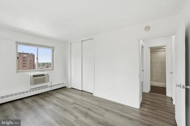 a view of a livingroom with wooden floor and window
