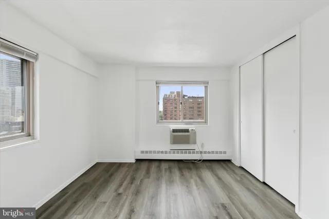 a view of a room with wooden floor and window