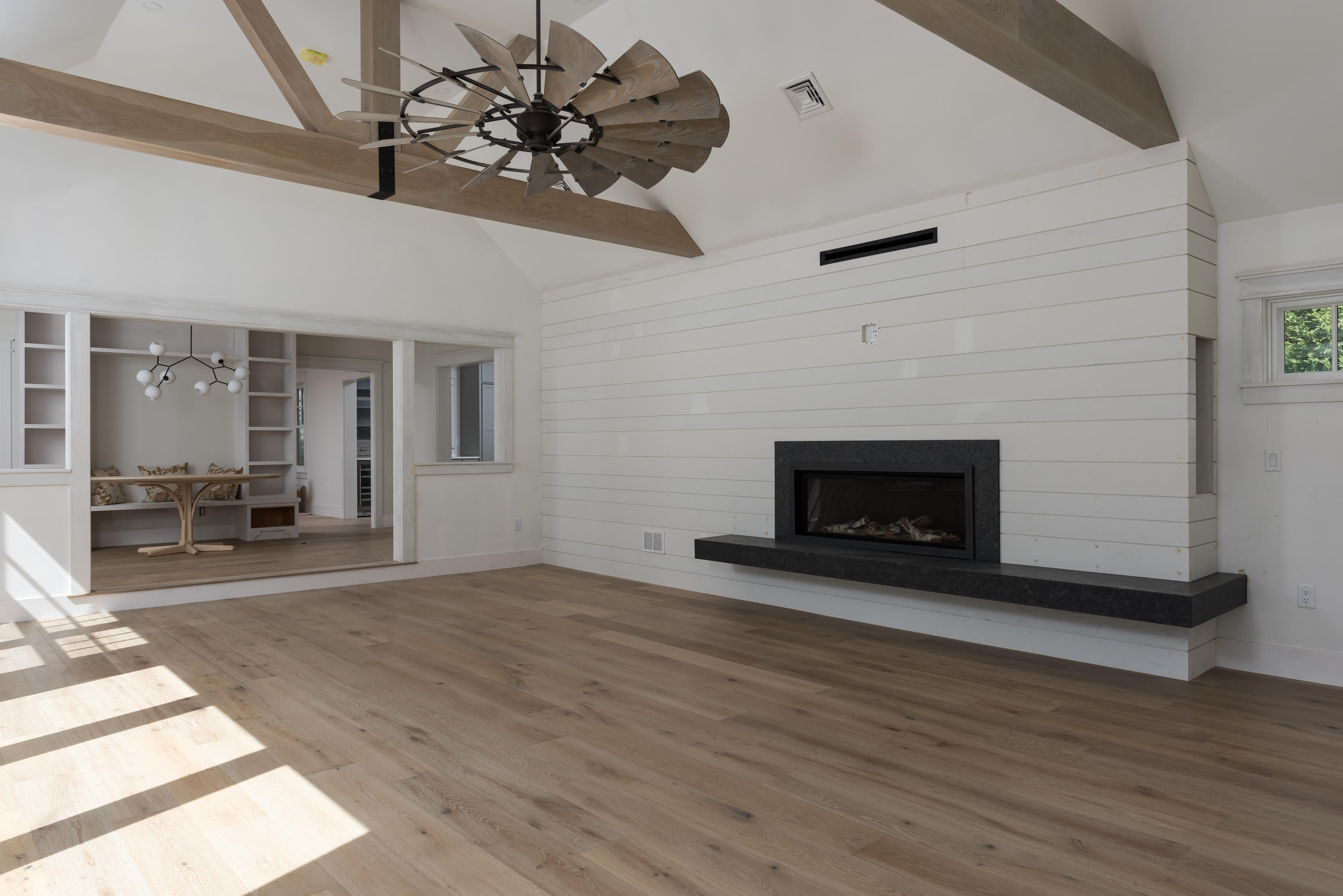 10 Eel River Road Osterville, MA 02655 - Photo 18 of 36 a view of a livingroom with a fireplace a chandelier and wooden floor