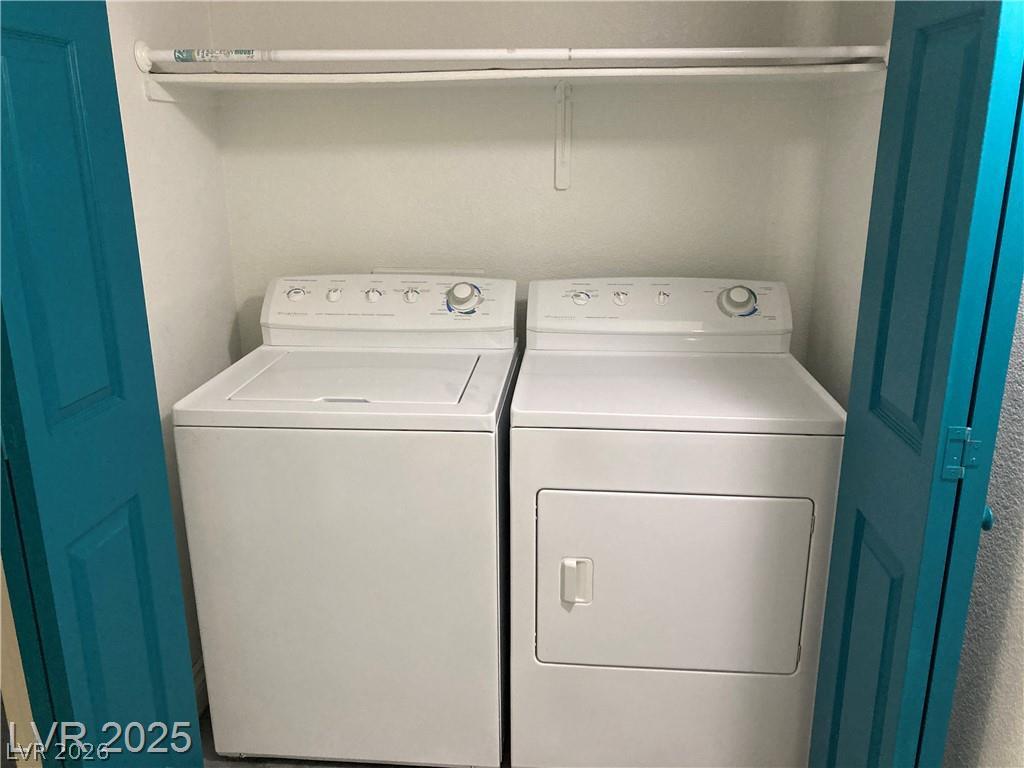 9050 West Warm Springs Road, Unit 1027 Las Vegas, NV 89148 - Photo 29 of 44 Functional laundry closet with a full-sized washer and dryer, optimizing utility in a compact area.