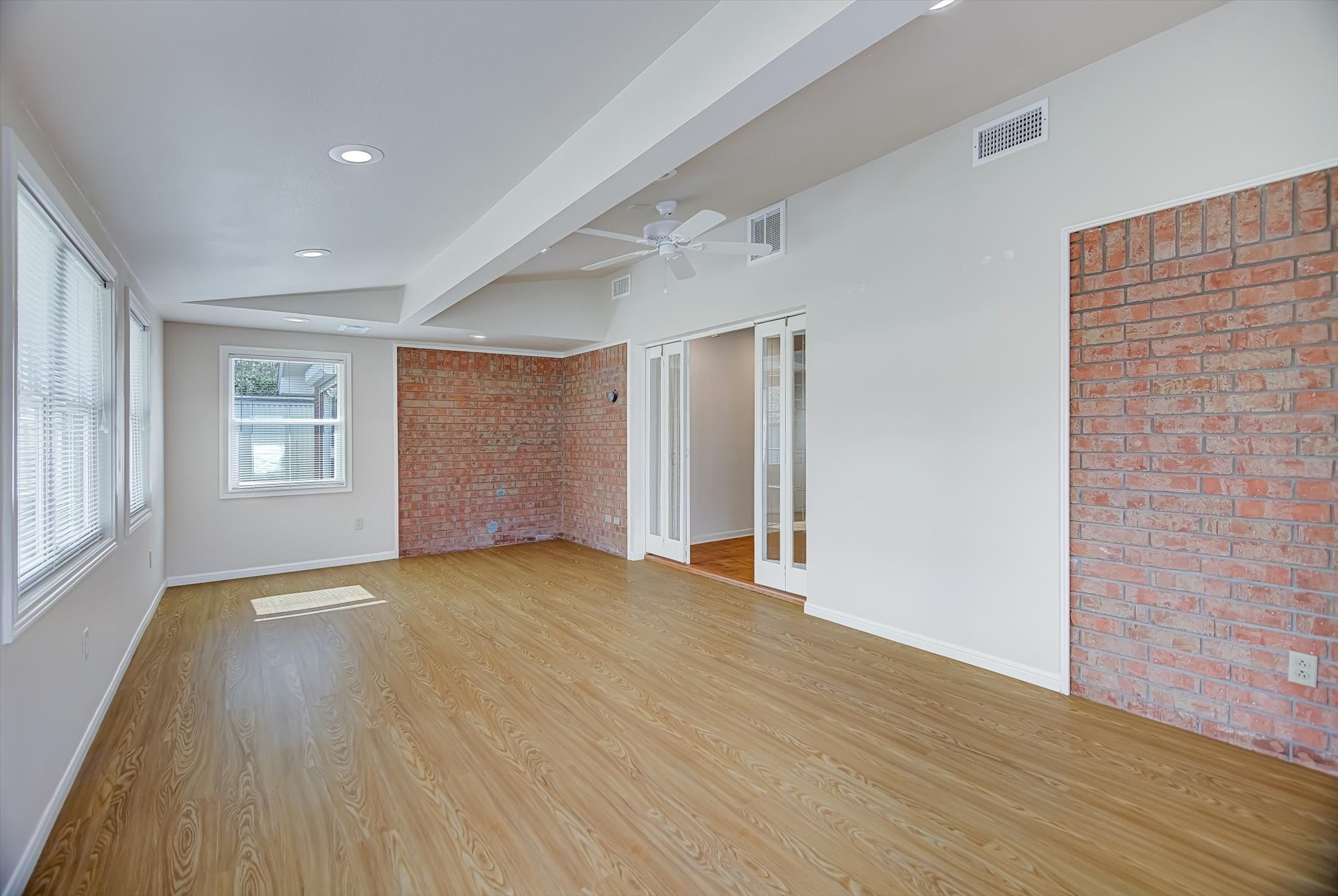 106 Woodland Road Lake Jackson, TX 77566 - Photo 11 of 46 a view of an empty room with wooden floor and a window