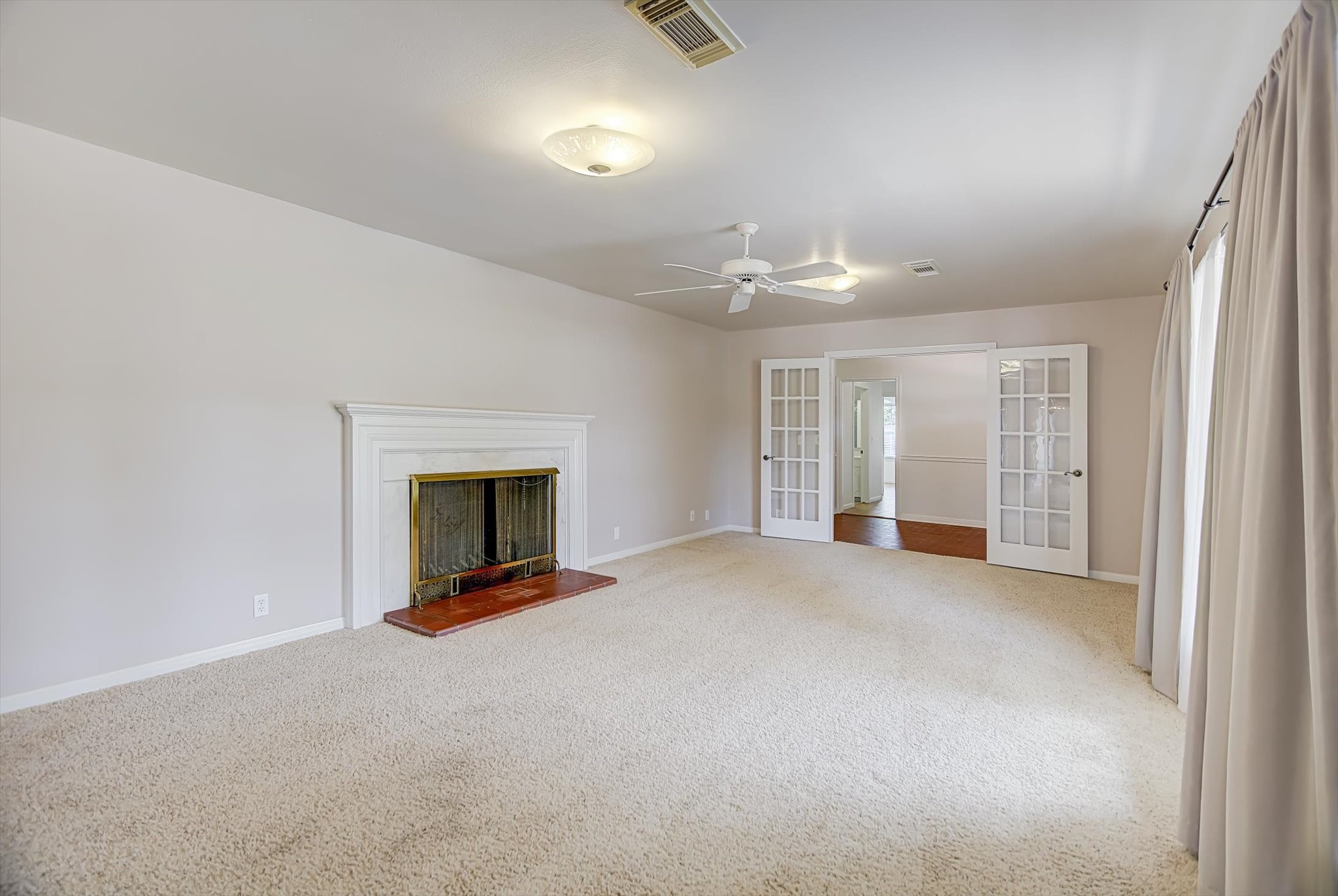 106 Woodland Road Lake Jackson, TX 77566 - Photo 13 of 46 a view of an empty room with a fireplace and a window