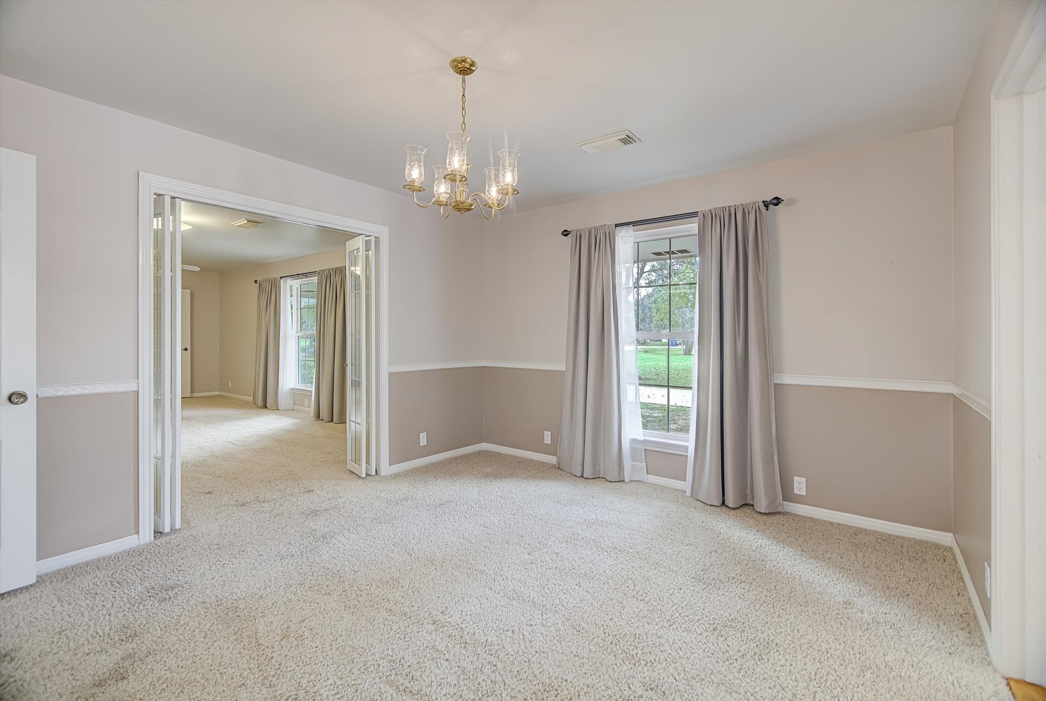 106 Woodland Road Lake Jackson, TX 77566 - Photo 15 of 46 a view of an empty room with chandelier and bathroom