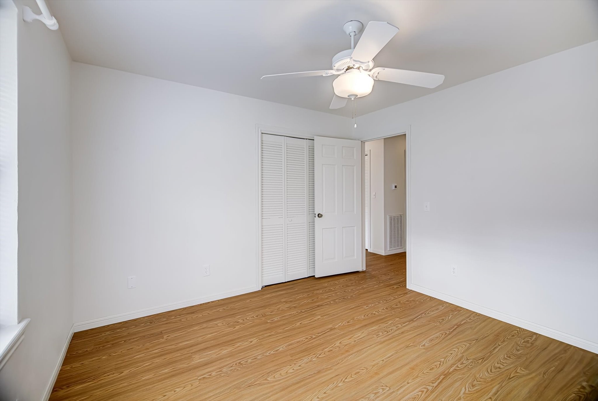 106 Woodland Road Lake Jackson, TX 77566 - Photo 31 of 46 a view of an empty room with wooden floor