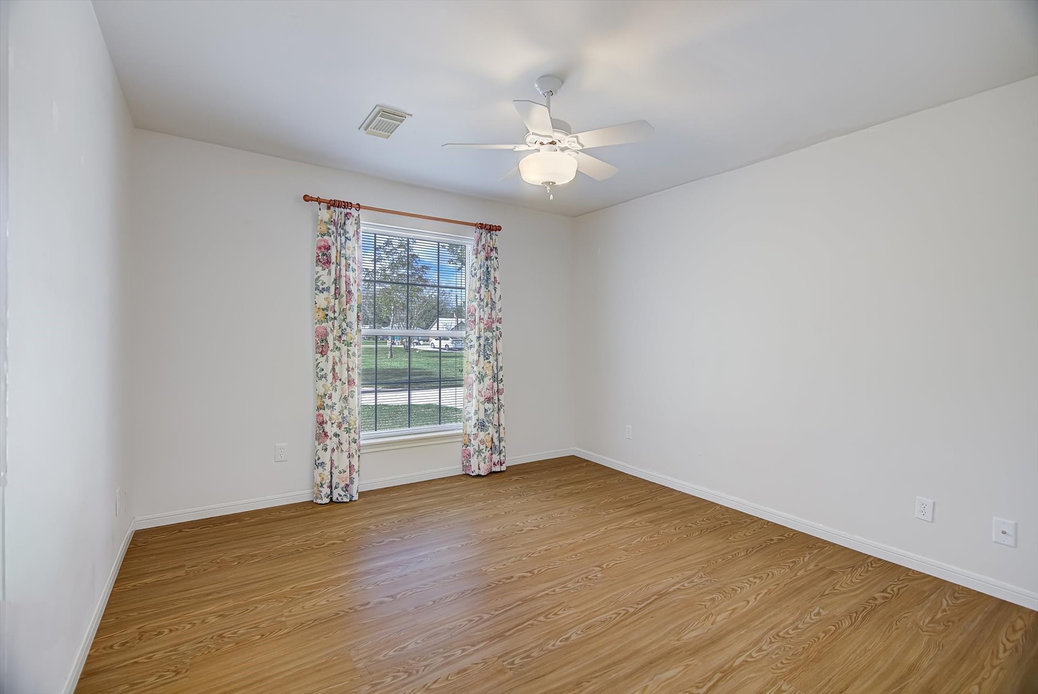106 Woodland Road Lake Jackson, TX 77566 - Photo 34 of 46 wooden floor in an empty room with a window