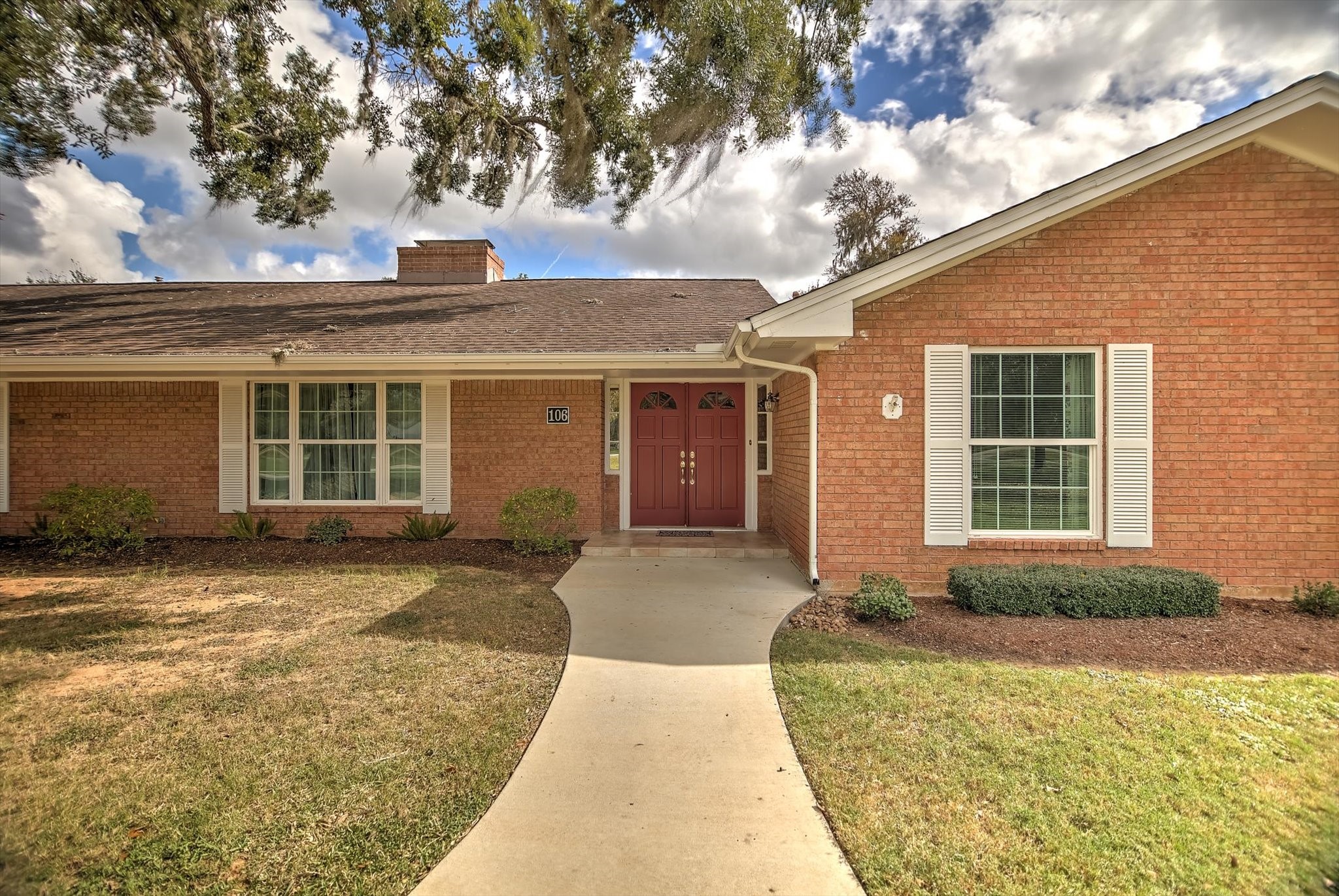 106 Woodland Road Lake Jackson, TX 77566 - Photo 46 of 46 a front view of a house with a yard and garage