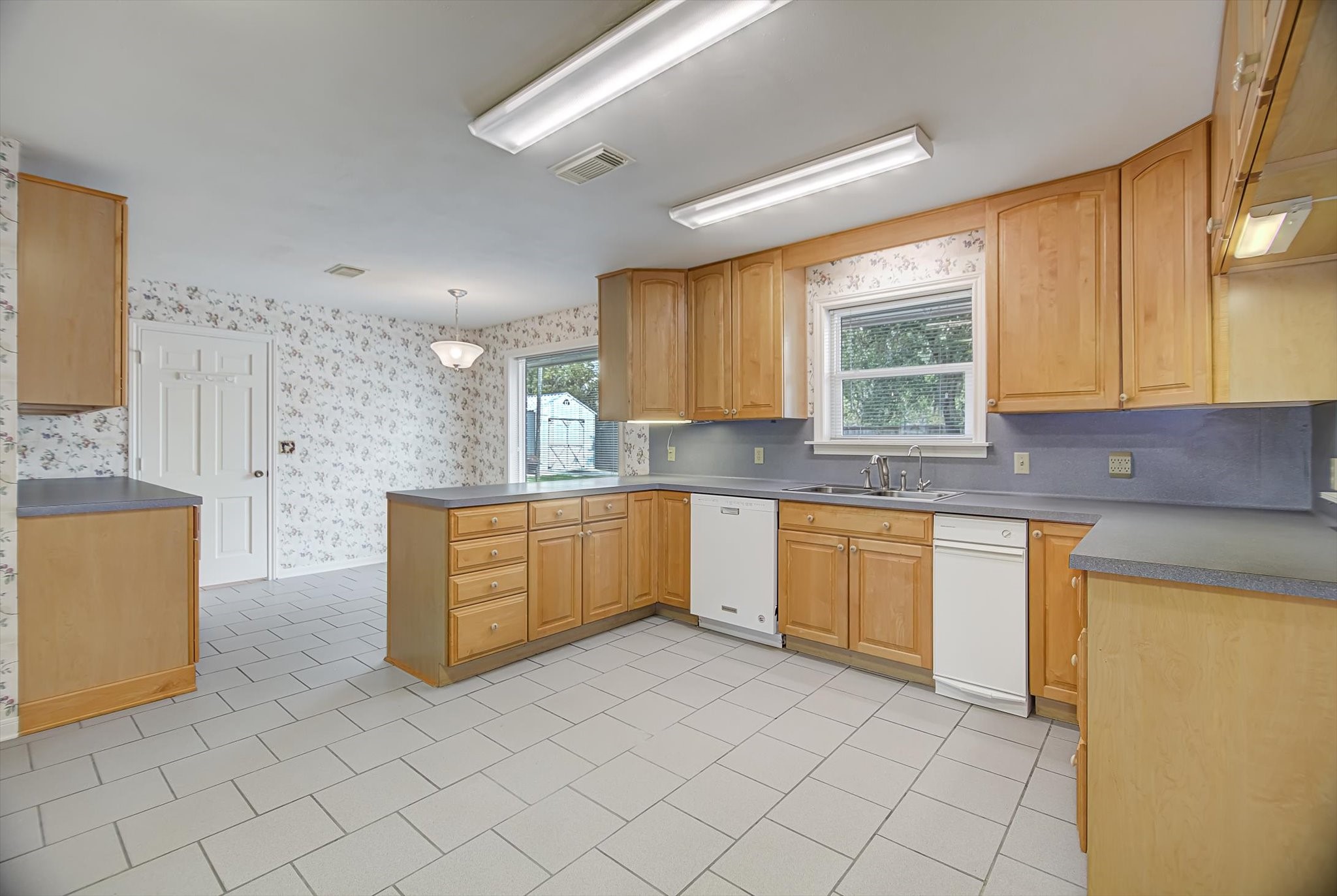 106 Woodland Road Lake Jackson, TX 77566 - Photo 7 of 46 a kitchen with stainless steel appliances granite countertop a sink and a stove top oven