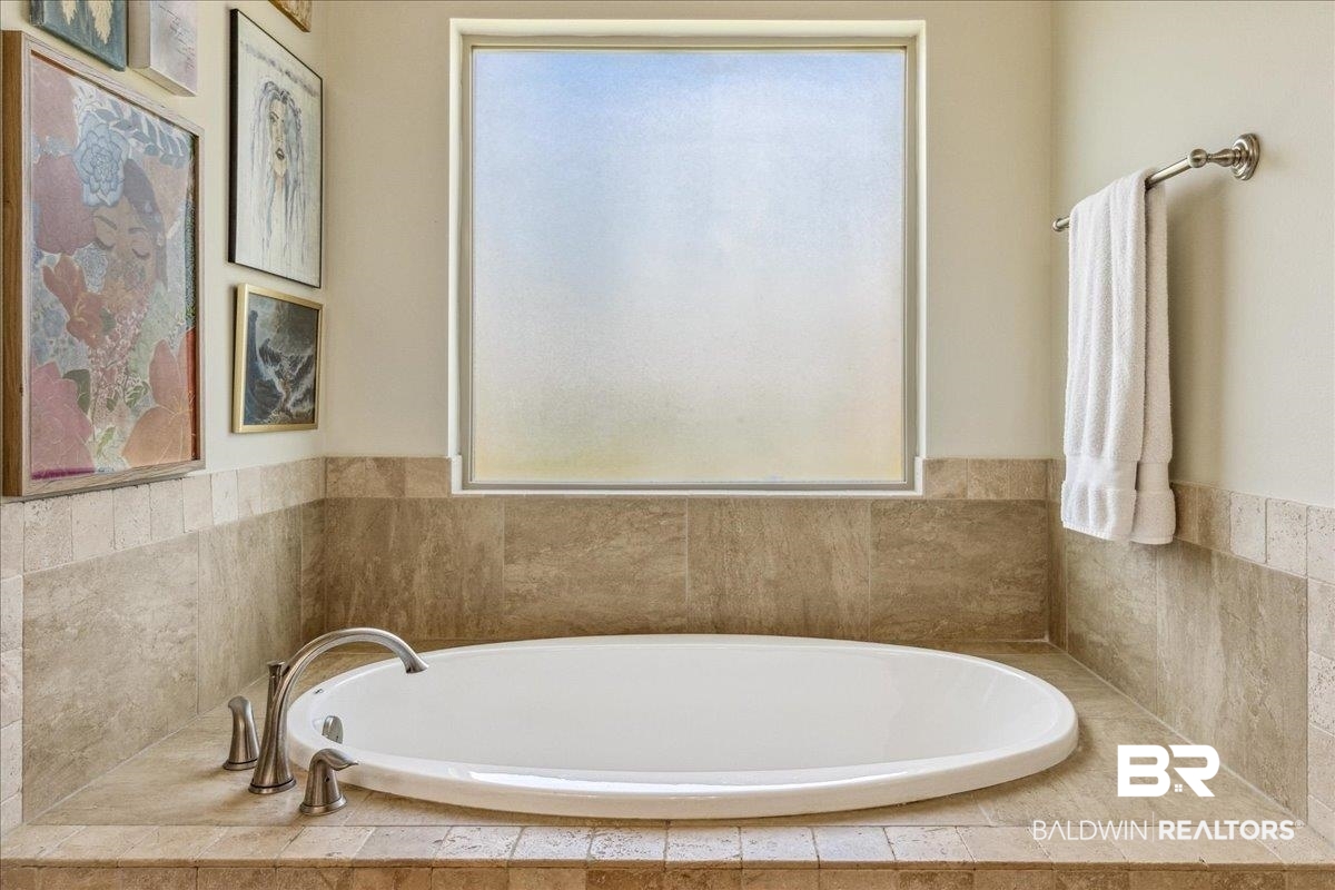 7088 Rocky Rd Loop Gulf Shores, AL 36542 - Photo 34 of 39 Bathroom with plenty of natural light and a garden tub