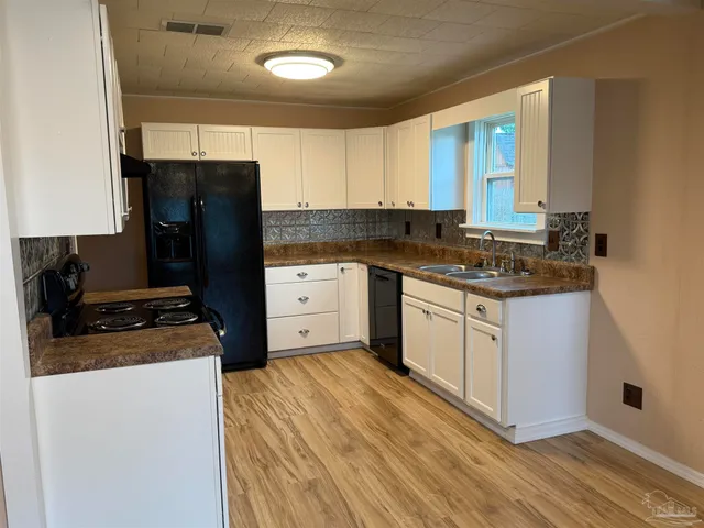 a kitchen with a sink stove and refrigerator