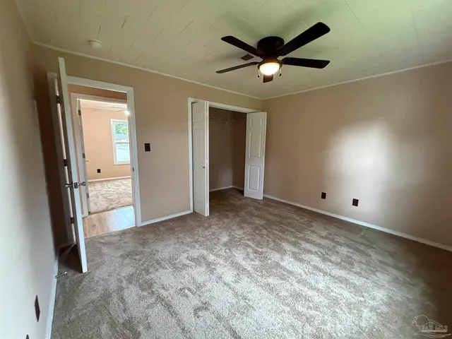 a view of a livingroom with a ceiling fan and wooden floor