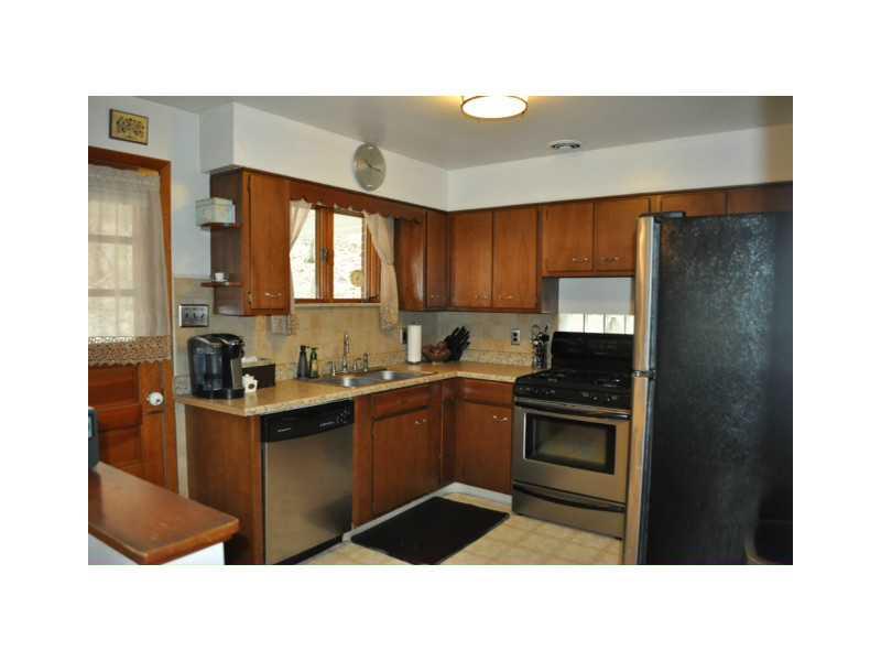 2398 Beaver Road Ambridge, PA 15003 - Photo 6 of 9 Kitchen. New stainless appliances, new counter tops, push button disposal. Access to covered deck.