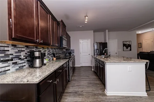 a kitchen with a stove top oven sink and cabinets