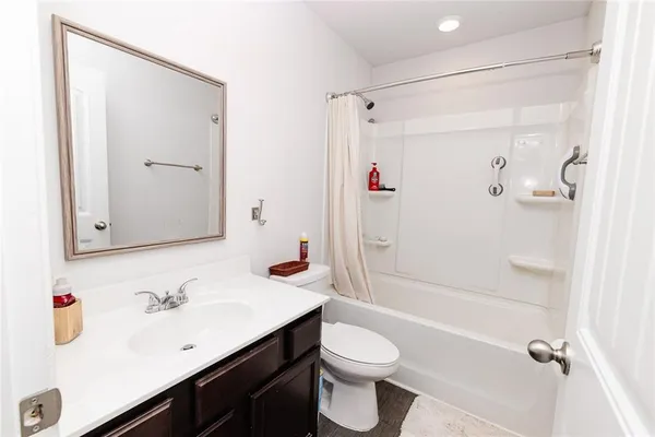 a view of a house with wooden fence