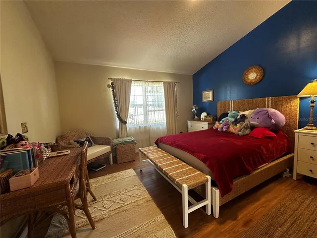 a bedroom with a bed and a potted plant