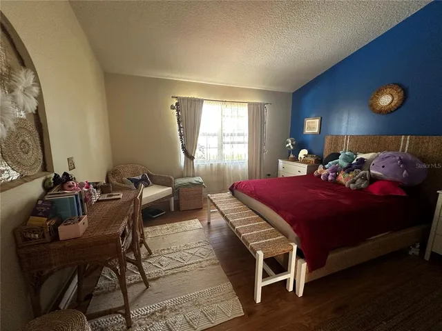 a bed room with a bed and chair