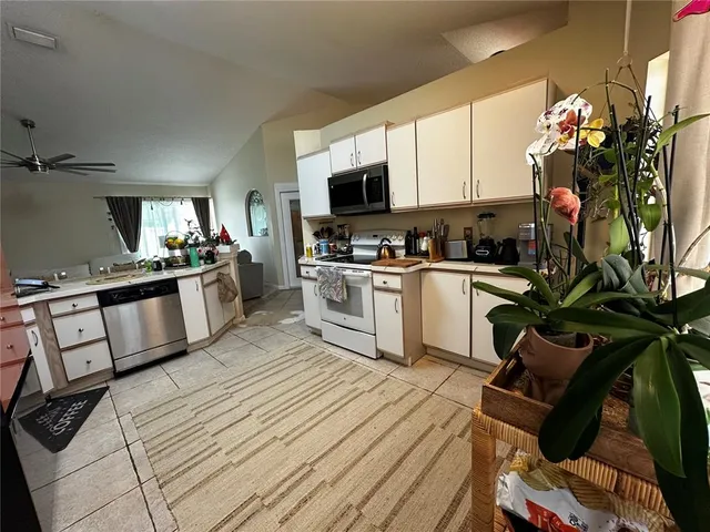 a kitchen with a sink appliances and cabinets