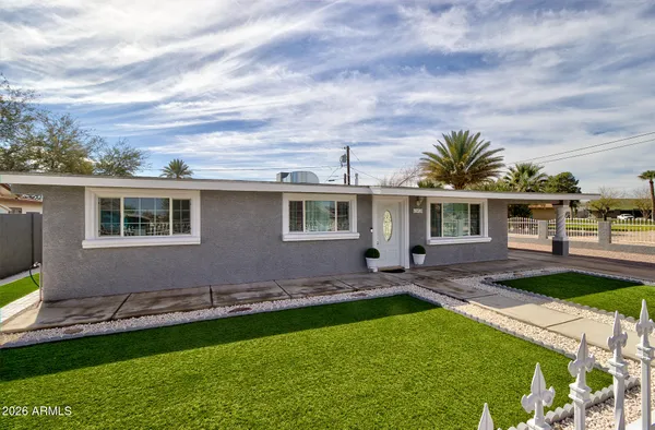 a front view of house with yard and outdoor seating