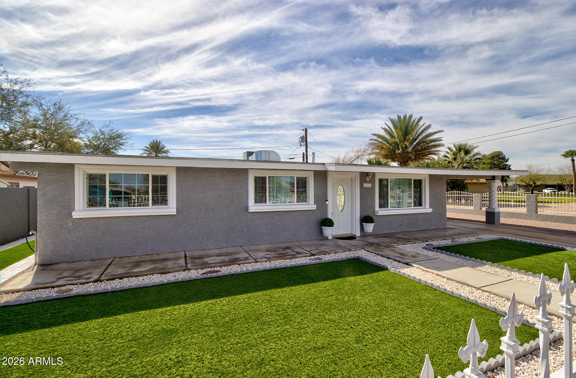 a front view of house with yard and outdoor seating