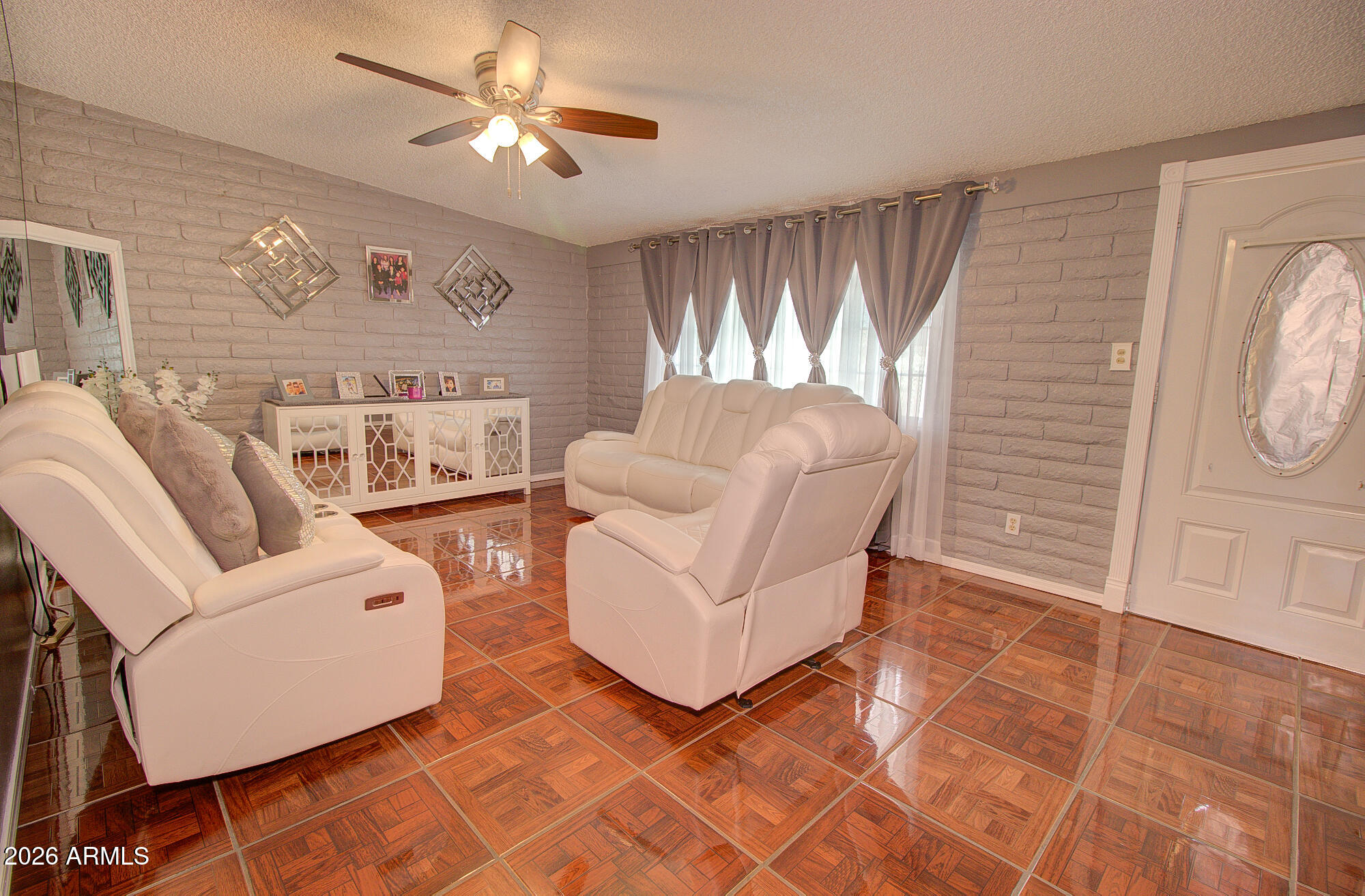 101 East 7th Street Eloy, AZ 85131 - Photo 12 of 34 a living room with furniture a flat screen tv and a window