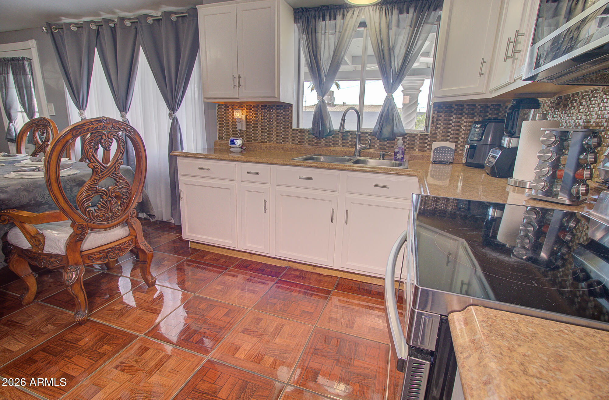 101 East 7th Street Eloy, AZ 85131 - Photo 15 of 34 a kitchen with stainless steel appliances granite countertop a sink a stove a microwave a sink and a refrigerator