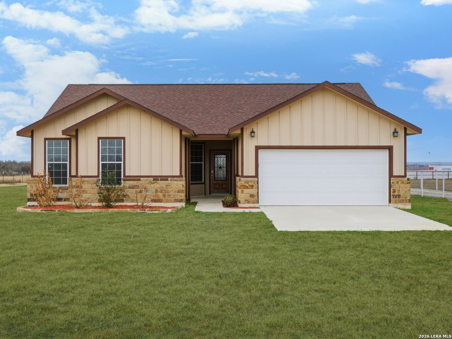 a front view of house with yard and garage
