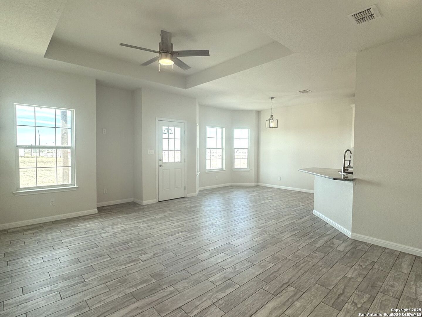 14329 Wisdom Road Atascosa, TX 78002 - Photo 4 of 5 a view of an empty room with a window and wooden floor