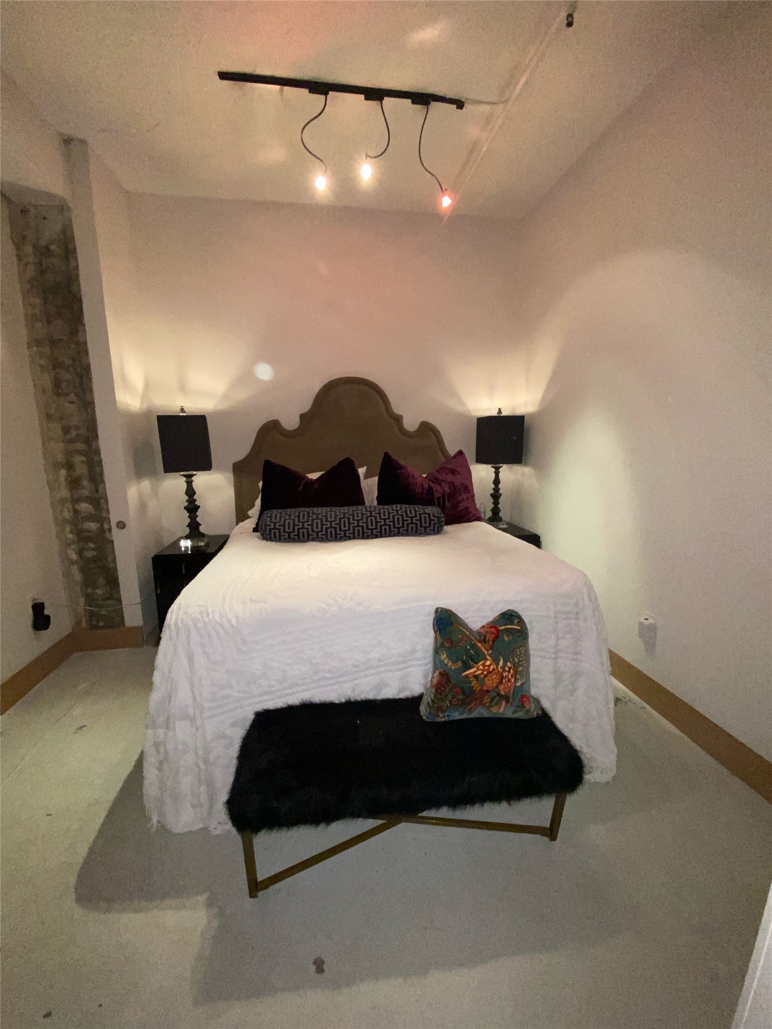 705 Main Street, Unit 311 Houston, TX 77002 - Photo 13 of 23 Bedroom with cement flooring and a spacious carpet.