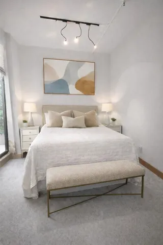 a bedroom with a bed and a night stand