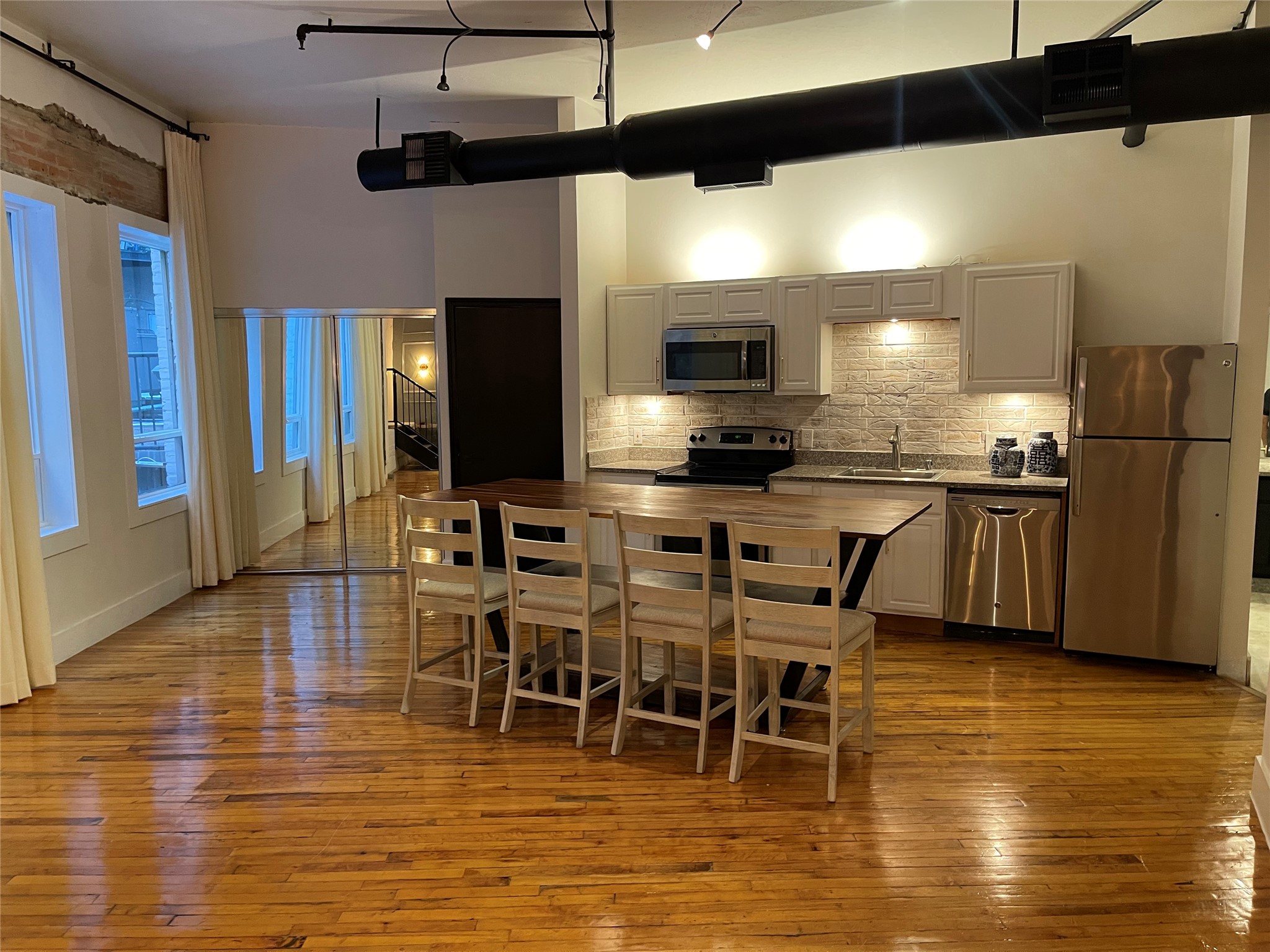 705 Main Street, Unit 311 Houston, TX 77002 - Photo 7 of 23 Downtown penthouse with and Amazing open kitchen, stainless appliances, white cabinetry, and an abundance of natural light.
