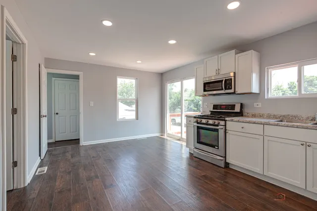 a kitchen with a stove a sink and a microwave