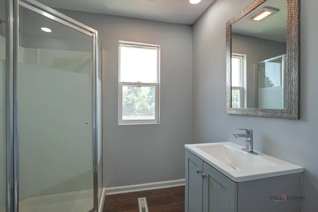 a bathroom with a sink vanity and a mirror