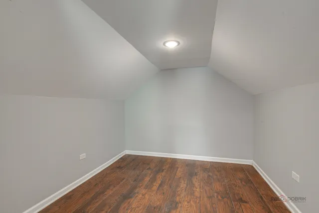 a view of an empty room and wooden floor