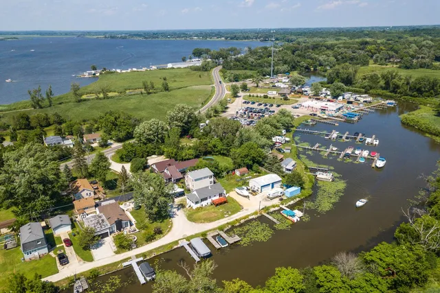 an aerial view of a house with a lake view